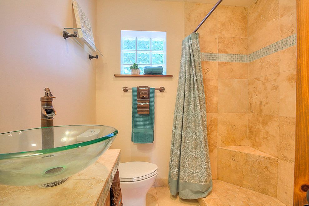 Double shower - small transitional master beige tile and ceramic tile travertine floor double shower idea in Albuquerque with a vessel sink, flat-panel cabinets, dark wood cabinets, tile countertops, a two-piece toilet and white walls