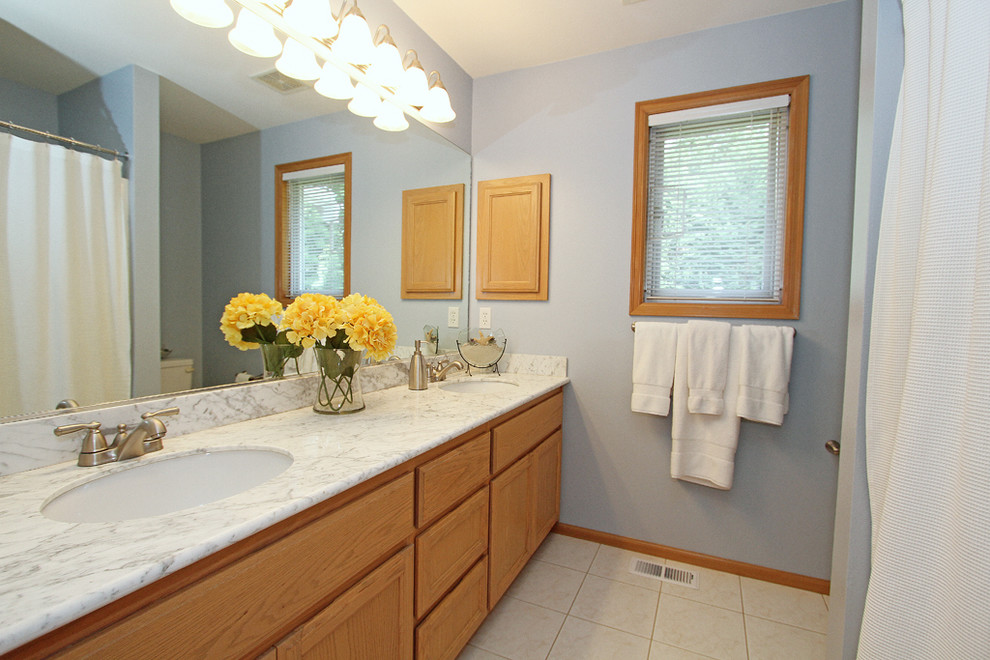 Идея дизайна: детская ванная комната в стиле неоклассика (современная классика) с фасадами с утопленной филенкой, светлыми деревянными фасадами, накладной ванной, душем над ванной, унитазом-моноблоком, синей плиткой, керамической плиткой, синими стенами, полом из керамической плитки, врезной раковиной, мраморной столешницей, белым полом и шторкой для ванной