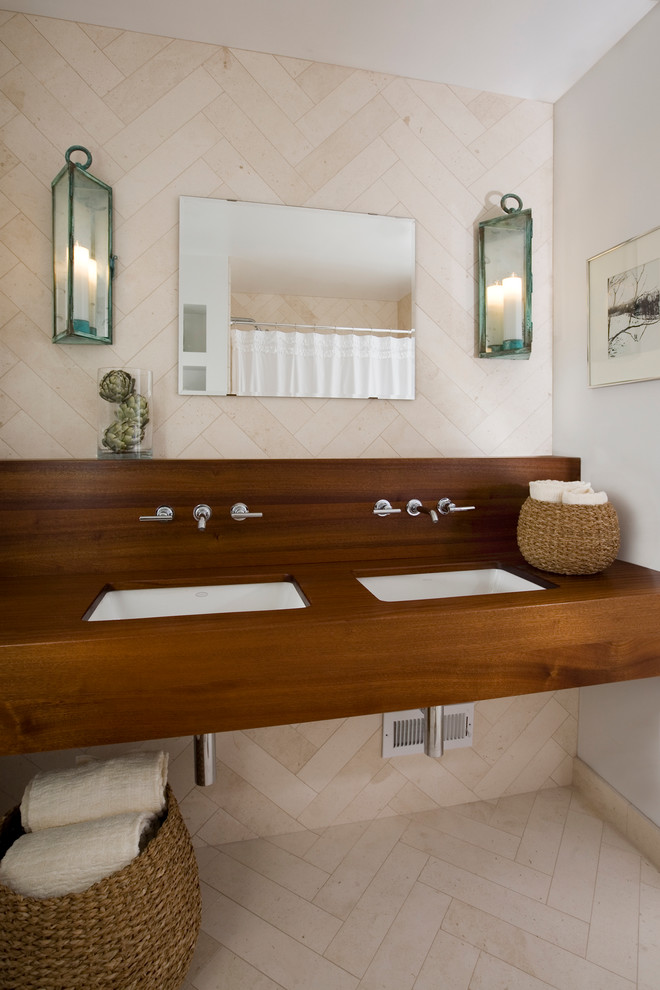 Photo of a medium sized modern bathroom in Atlanta with a submerged sink, wooden worktops, an alcove bath, a shower/bath combination, beige tiles, stone tiles, white walls and limestone flooring.