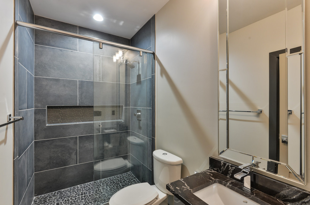Inspiration for a mid-sized transitional master gray tile and stone tile vinyl floor alcove shower remodel in Louisville with flat-panel cabinets, distressed cabinets, a two-piece toilet, white walls, an undermount sink and marble countertops