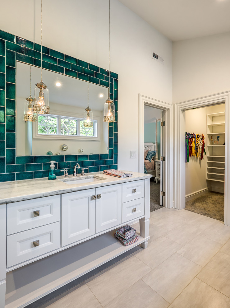Bathroom - huge transitional 3/4 porcelain tile and gray floor bathroom idea in Cincinnati with furniture-like cabinets, white cabinets, white walls, an undermount sink, marble countertops, a hinged shower door and multicolored countertops