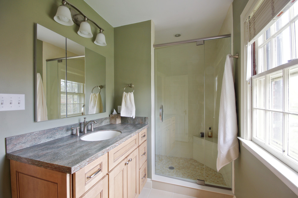 Example of a mid-sized trendy master beige tile and ceramic tile ceramic tile alcove shower design in Baltimore with an undermount sink, recessed-panel cabinets, light wood cabinets, solid surface countertops and green walls