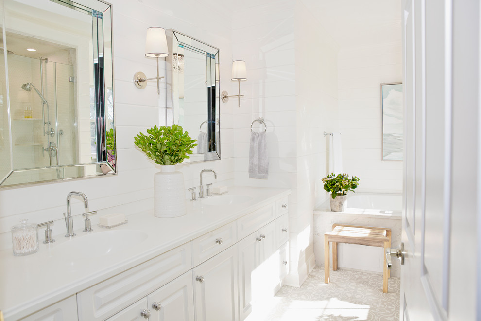 Inspiration for a small coastal master white tile and marble tile cement tile floor and gray floor bathroom remodel in New York with raised-panel cabinets, white cabinets, a one-piece toilet, white walls, an undermount sink, marble countertops and a hinged shower door