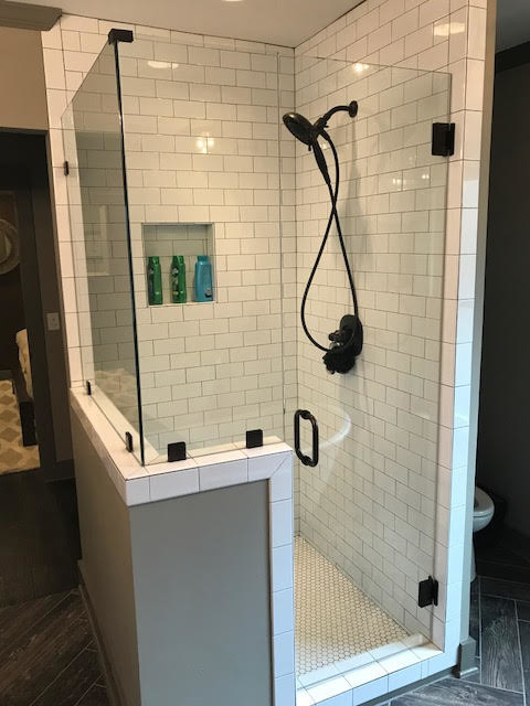 This is an example of a large traditional shower room bathroom in Birmingham with beige walls, laminate floors, grey floors, a corner shower, a two-piece toilet, white tiles, metro tiles, a pedestal sink, solid surface worktops, a hinged door and white worktops.