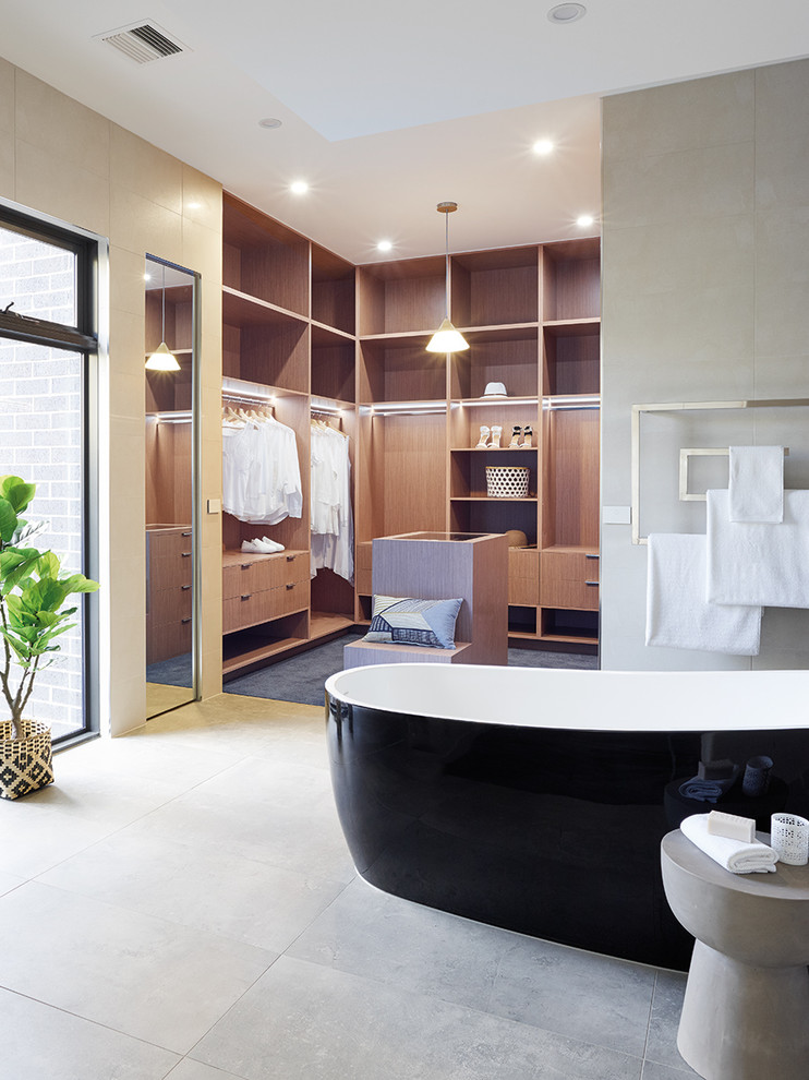 Inspiration for a large contemporary ensuite bathroom in Melbourne with freestanding cabinets, medium wood cabinets, a freestanding bath, grey tiles, ceramic tiles, ceramic flooring and wooden worktops.