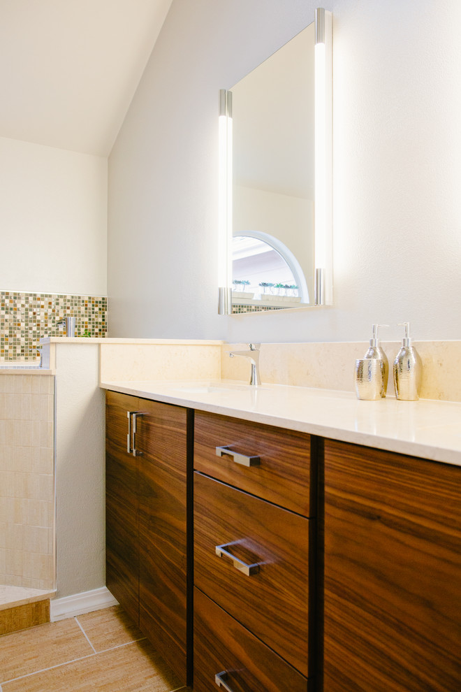 Photo of a medium sized world-inspired ensuite bathroom in Denver with flat-panel cabinets, medium wood cabinets, a japanese bath, a shower/bath combination, a two-piece toilet, beige tiles, porcelain tiles, white walls, porcelain flooring, a submerged sink and engineered stone worktops.