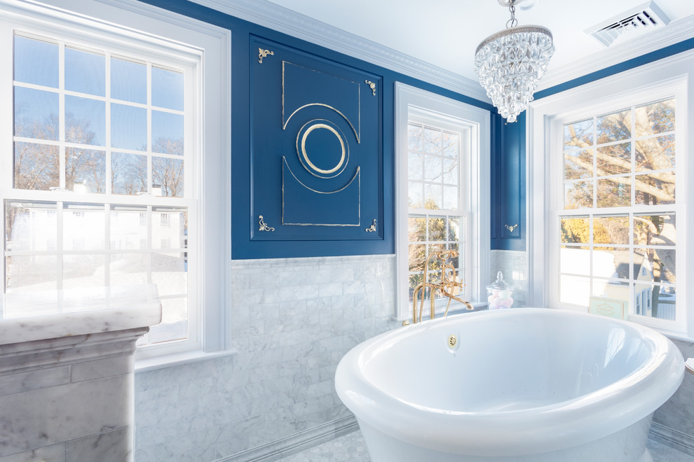 Inspiration for a medium sized classic ensuite bathroom in Boston with a freestanding bath, an alcove shower, a one-piece toilet, grey tiles, marble tiles, blue walls, marble flooring, a submerged sink, marble worktops, grey floors, a hinged door and grey worktops.