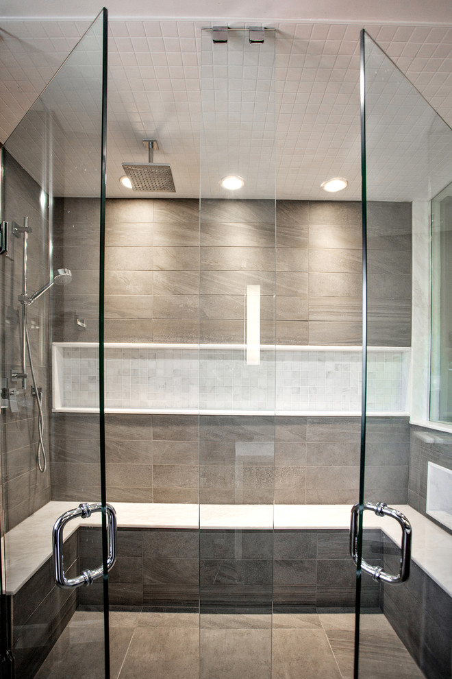 Inspiration for a mid-sized modern master gray tile and porcelain tile walk-in shower remodel in Toronto with an undermount sink, flat-panel cabinets, medium tone wood cabinets, marble countertops and a wall-mount toilet