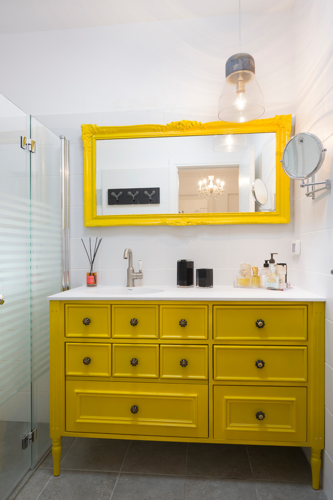 Réalisation d'une salle de bain grise et jaune bohème avec des portes de placard jaunes, une douche à l'italienne, un carrelage blanc, un mur blanc et un placard avec porte à panneau encastré.