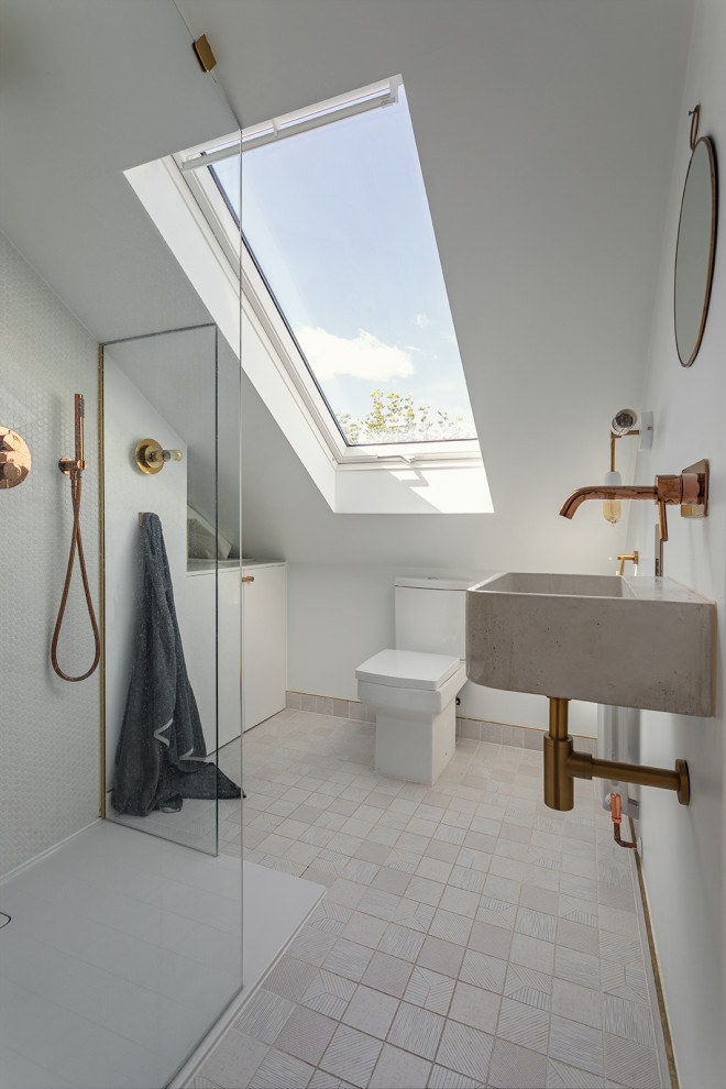 Photo of a contemporary bathroom in London with a corner shower, white walls, a wall-mounted sink, white floors and a single sink.