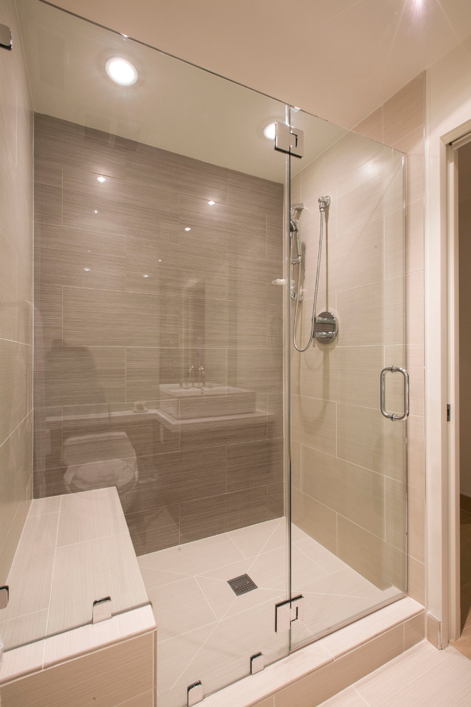 This is an example of a small contemporary bathroom in DC Metro with a vessel sink, an alcove shower, a one-piece toilet, beige tiles, porcelain tiles, white walls and porcelain flooring.