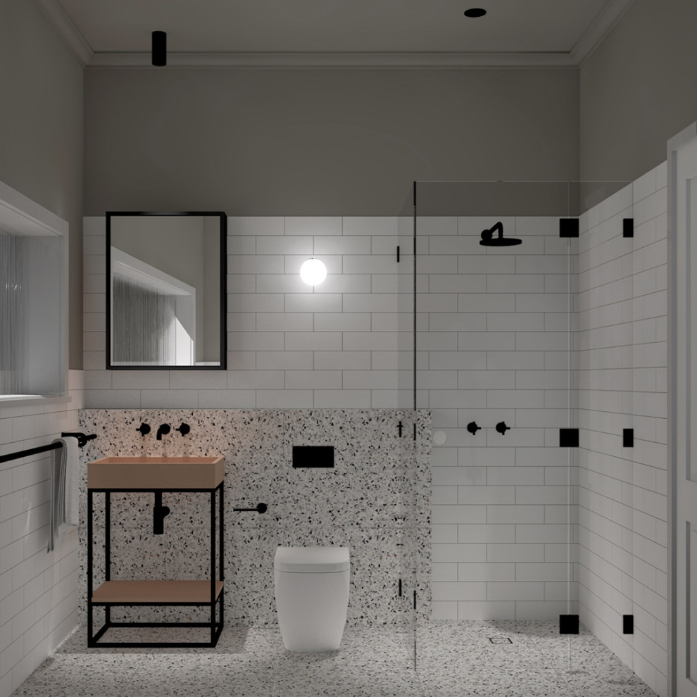 Foto på ett funkis orange badrum för barn, med svarta skåp, ett fristående badkar, en hörndusch, en toalettstol med hel cisternkåpa, vit kakel, keramikplattor, vita väggar, terrazzogolv, ett avlångt handfat, bänkskiva i betong, beiget golv och dusch med gångjärnsdörr