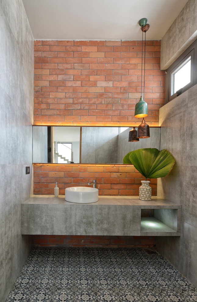Photo of an industrial bathroom in Ahmedabad with grey tiles, cement tiles, grey walls, ceramic flooring, a vessel sink, concrete worktops, multi-coloured floors and grey worktops.