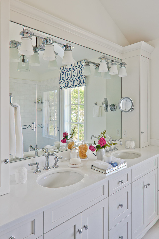 Example of a beach style master porcelain tile bathroom design in Boston with an undermount sink, recessed-panel cabinets, white cabinets, quartz countertops and white walls