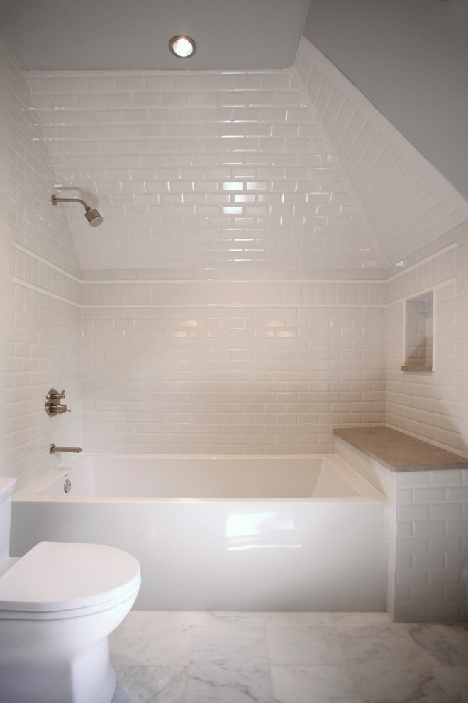 Tub/shower combo - mid-sized contemporary 3/4 white tile and ceramic tile marble floor tub/shower combo idea in Atlanta with an undermount sink, recessed-panel cabinets, white cabinets, limestone countertops, a one-piece toilet and gray walls