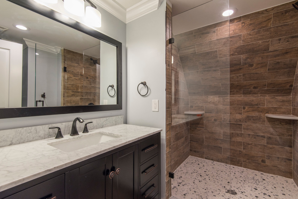 Design ideas for a medium sized classic shower room bathroom in Philadelphia with shaker cabinets, black cabinets, an alcove shower, a two-piece toilet, brown tiles, porcelain tiles, grey walls, pebble tile flooring, a submerged sink, engineered stone worktops and a hinged door.