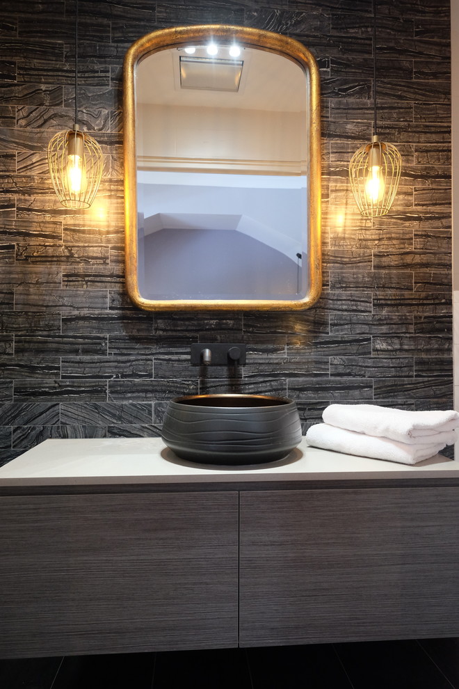 Design ideas for a small contemporary ensuite bathroom in Sydney with flat-panel cabinets, grey cabinets, a built-in shower, a wall mounted toilet, black tiles, porcelain tiles, black walls, porcelain flooring, a vessel sink, engineered stone worktops, grey floors, a sliding door and white worktops.