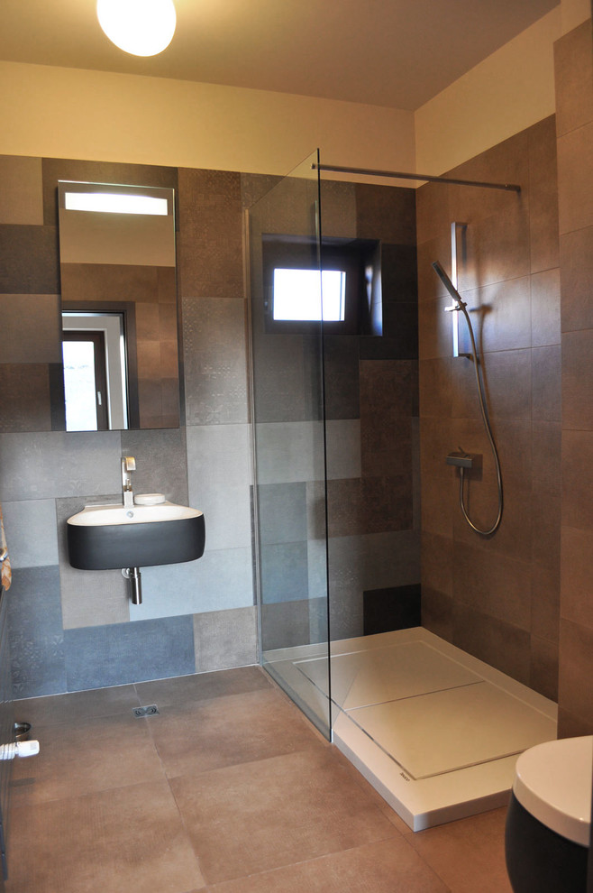 Inspiration for a medium sized eclectic shower room bathroom in Other with a freestanding bath, a walk-in shower, a wall mounted toilet, grey tiles, ceramic tiles, grey walls and ceramic flooring.