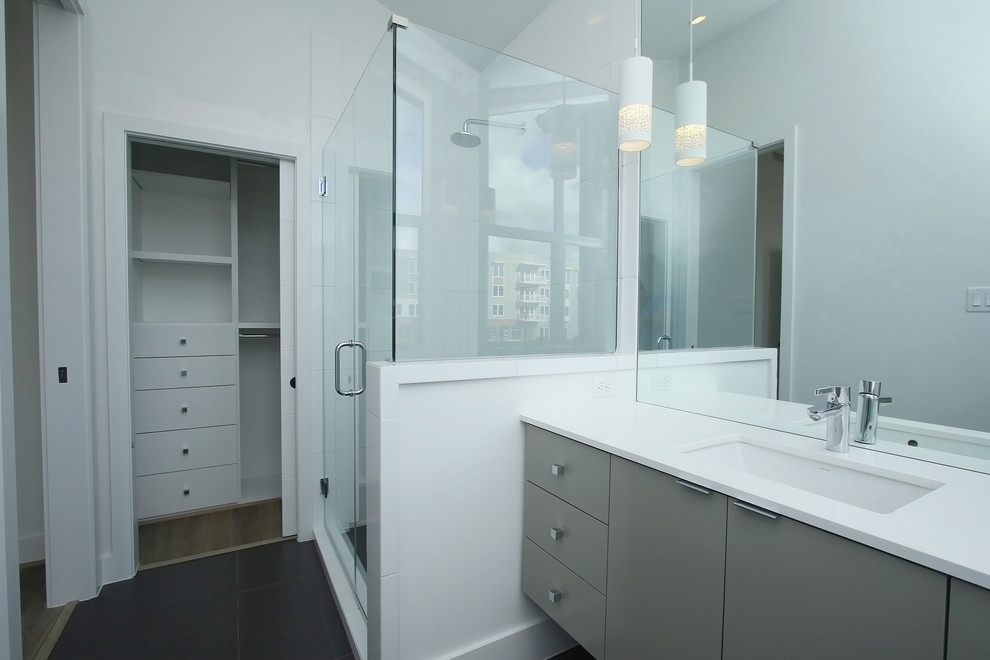 Inspiration för små moderna badrum, med ett undermonterad handfat, släta luckor, grå skåp, bänkskiva i akrylsten, en dusch i en alkov, en toalettstol med separat cisternkåpa, svart kakel, porslinskakel, vita väggar och klinkergolv i porslin