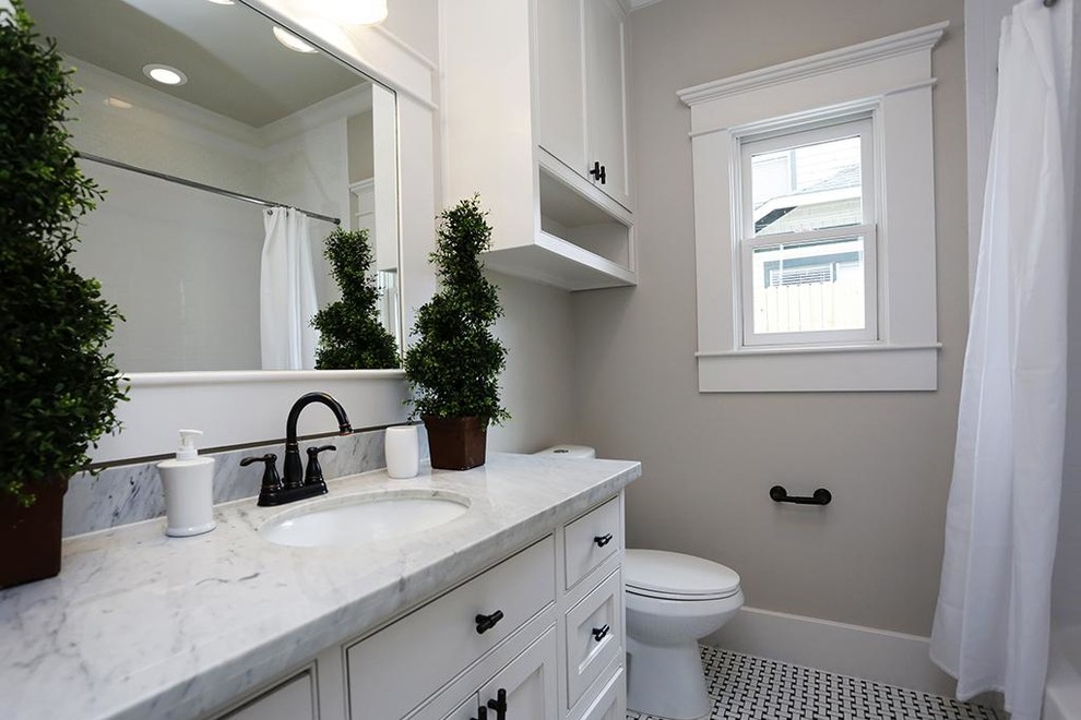 Mid-sized arts and crafts white tile and mosaic tile mosaic tile floor bathroom photo in Denver with an undermount sink, shaker cabinets, white cabinets, marble countertops, a one-piece toilet and gray walls