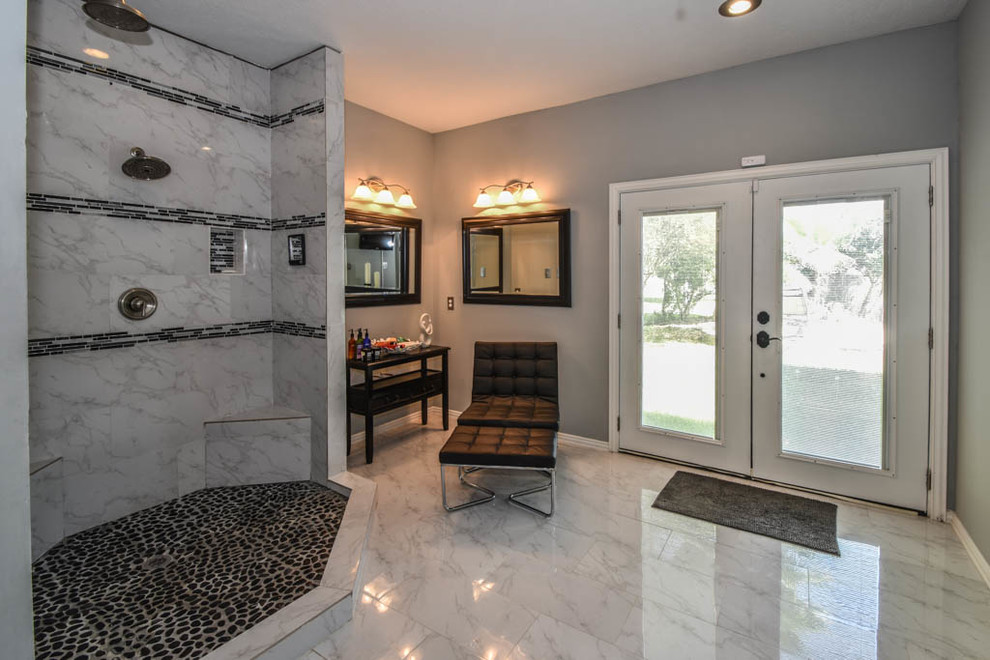 Large contemporary ensuite bathroom in Houston with glass-front cabinets, black cabinets, a walk-in shower, white tiles, stone tiles, grey walls, marble flooring, a vessel sink and marble worktops.