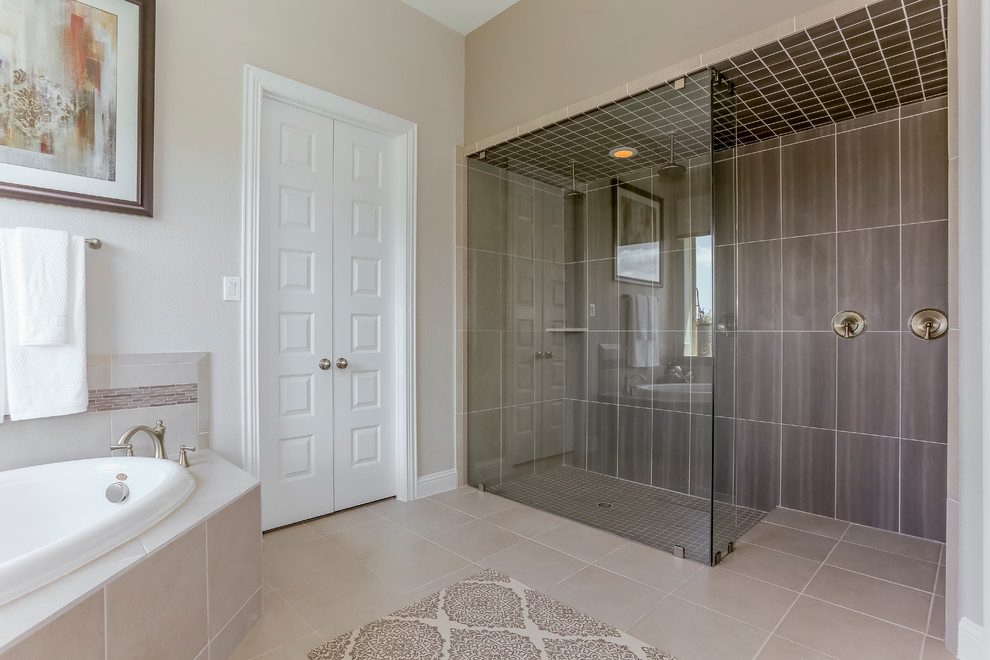 Large transitional master beige tile and stone tile ceramic tile and beige floor bathroom photo in Houston with recessed-panel cabinets, dark wood cabinets, beige walls, an undermount sink and solid surface countertops