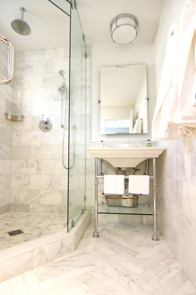 Inspiration for a small transitional white tile marble floor corner shower remodel in San Diego with a console sink, a wall-mount toilet, furniture-like cabinets, solid surface countertops and white walls