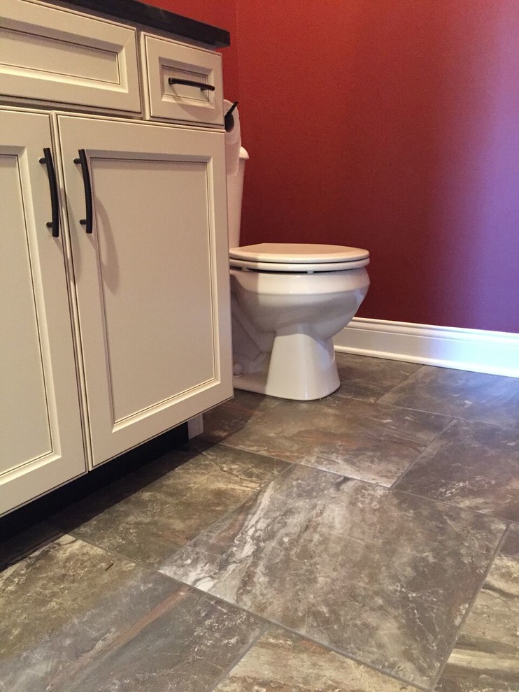 Example of a mid-sized classic 3/4 beige tile bathroom design in Other with shaker cabinets, white cabinets, a one-piece toilet, red walls, an undermount sink and granite countertops