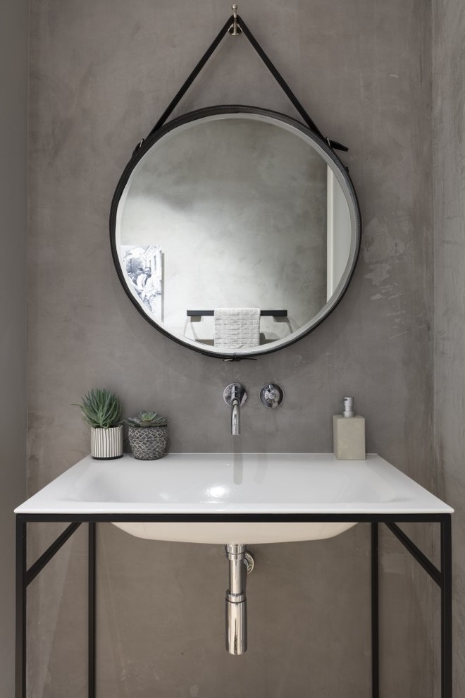 Diseño de cuarto de baño actual con paredes grises y lavabo tipo consola
