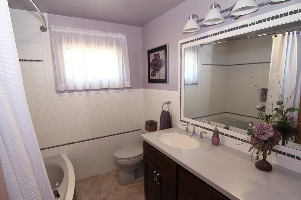 Bathroom - small transitional master white tile and subway tile vinyl floor bathroom idea in Milwaukee with flat-panel cabinets, dark wood cabinets, a two-piece toilet, purple walls, an integrated sink and solid surface countertops
