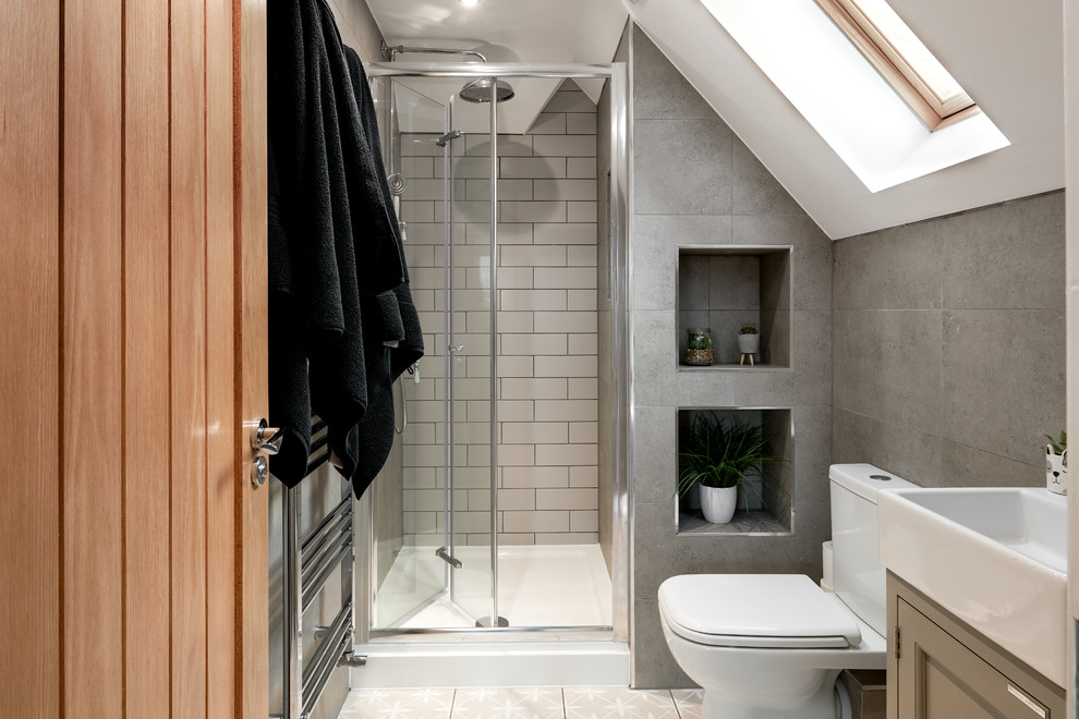 Example of a mid-sized transitional master white tile mosaic tile floor and gray floor drop-in bathtub design in Hampshire with gray walls