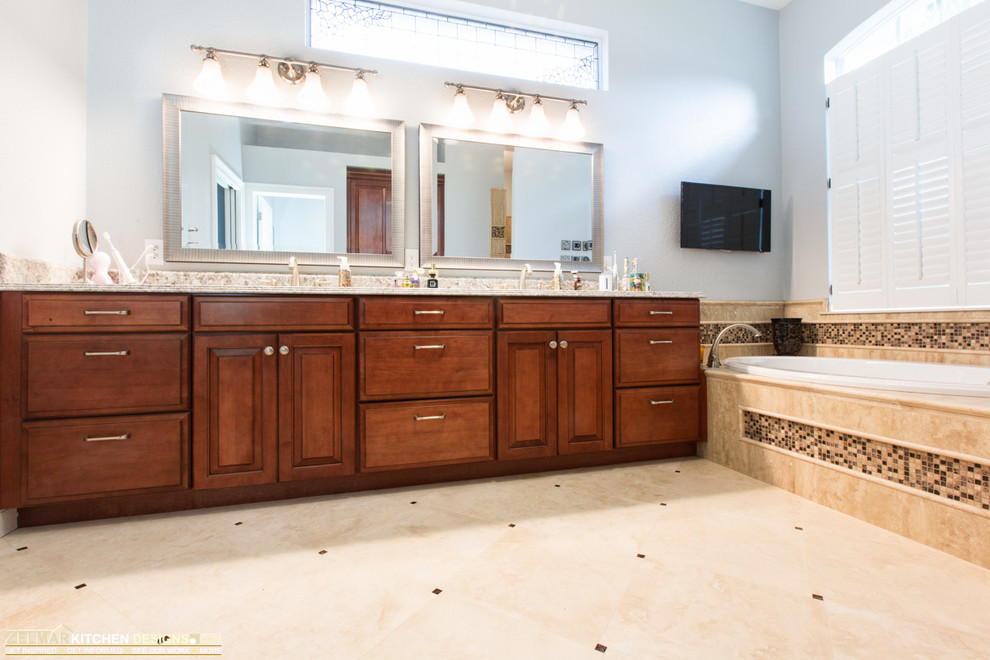 Inspiration for a large classic ensuite bathroom in Orlando with a submerged sink, raised-panel cabinets, medium wood cabinets, engineered stone worktops, a built-in bath, a walk-in shower, beige tiles, stone tiles and travertine flooring.