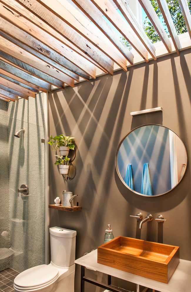 Photo of a medium sized contemporary bathroom in Houston with an alcove shower, a two-piece toilet, white tiles, mosaic tiles, brown walls, a vessel sink and open cabinets.