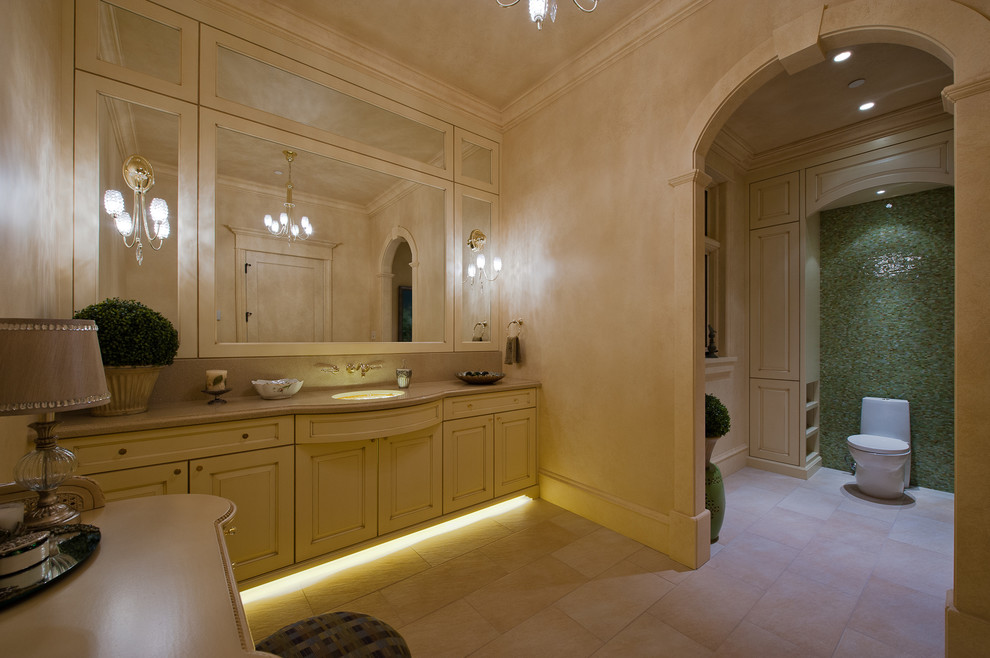 Exemple d'une grande salle de bain principale montagne avec un lavabo encastré, un placard avec porte à panneau surélevé, des portes de placard jaunes, un plan de toilette en granite, WC à poser, un carrelage multicolore, un carrelage en pâte de verre, un mur beige et un sol en carrelage de céramique.