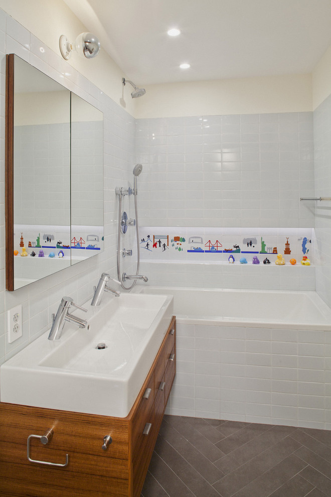 Bathroom - modern kids' white tile and subway tile bathroom idea in New York with a trough sink, flat-panel cabinets and medium tone wood cabinets
