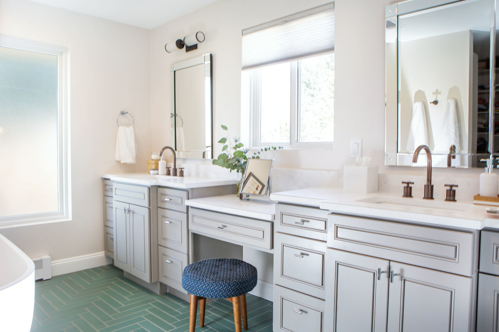 Large traditional ensuite bathroom in Denver with raised-panel cabinets, grey cabinets, a freestanding bath, an alcove shower, a one-piece toilet, green tiles, ceramic tiles, white walls, ceramic flooring, a submerged sink, engineered stone worktops, green floors, a hinged door and white worktops.