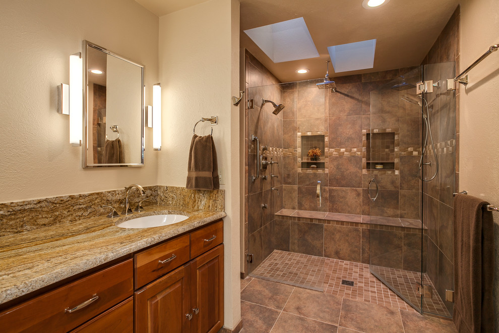 Bathroom - large modern master brown tile and ceramic tile ceramic tile bathroom idea in Denver with raised-panel cabinets, medium tone wood cabinets, granite countertops and beige walls