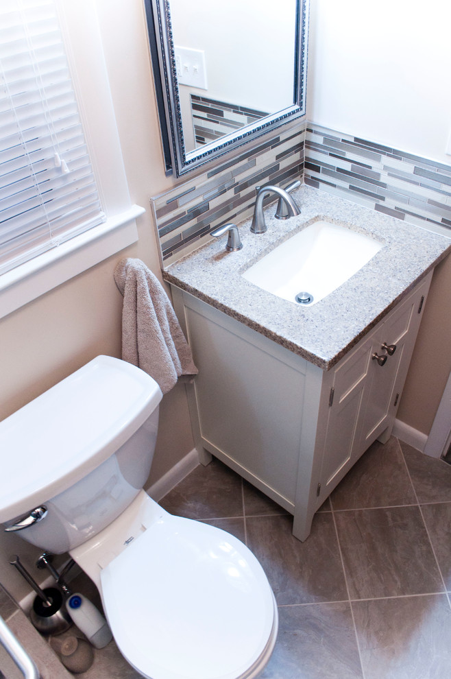Photo of a small contemporary shower room bathroom in Other with white cabinets, a two-piece toilet, beige tiles, beige walls, ceramic flooring, shaker cabinets, an alcove shower, ceramic tiles, a submerged sink, laminate worktops, grey floors and a sliding door.