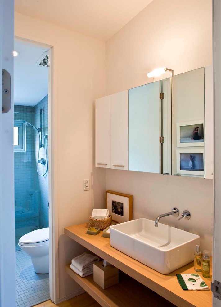 Cette photo montre une douche en alcôve tendance avec une vasque, un plan de toilette en bois et un carrelage gris.