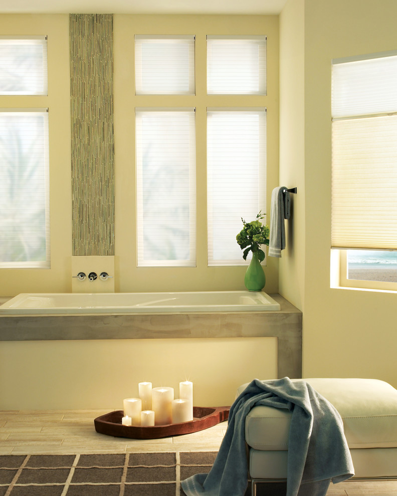 Inspiration for a mid-sized transitional master light wood floor drop-in bathtub remodel in Phoenix with beige walls