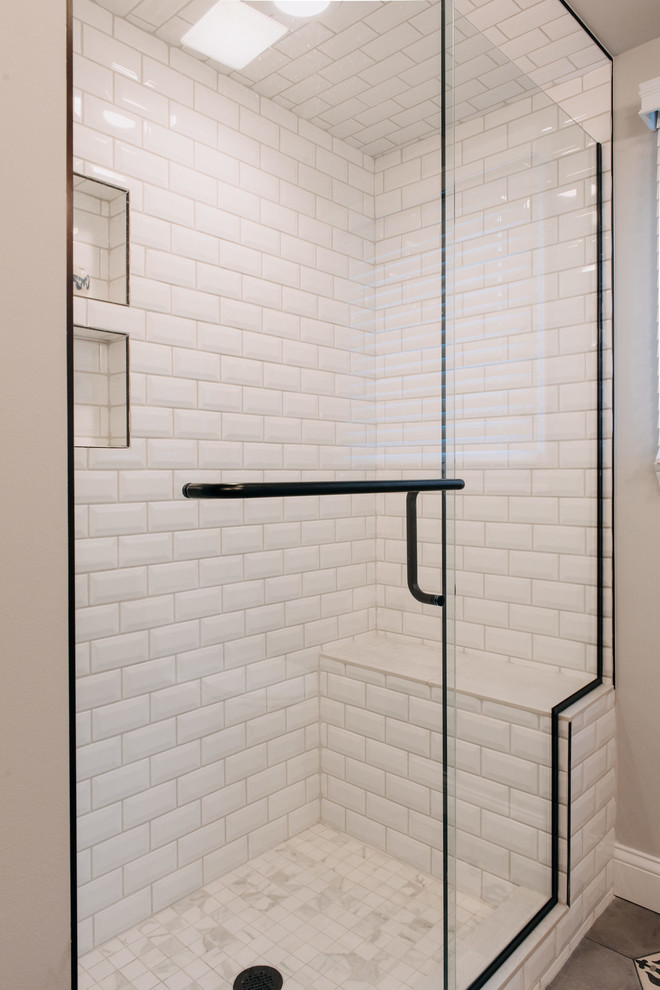 Doorless shower - mid-sized shabby-chic style 3/4 white tile and porcelain tile porcelain tile and gray floor doorless shower idea in Detroit with shaker cabinets, distressed cabinets, a one-piece toilet, gray walls, an undermount sink, quartz countertops and a hinged shower door