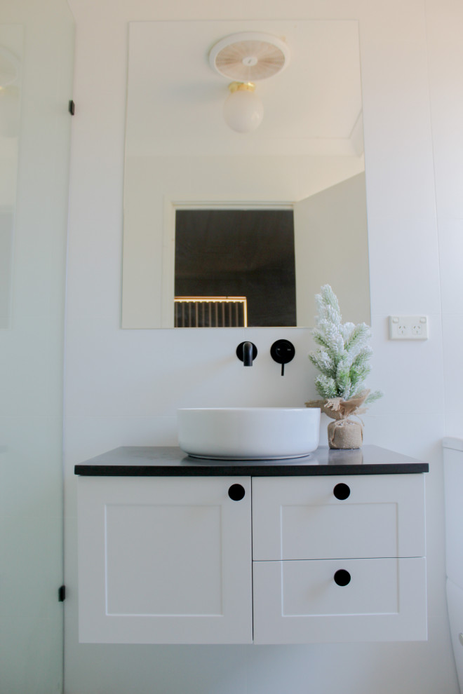Small modern ensuite bathroom in Perth with shaker cabinets, white cabinets, a walk-in shower, a two-piece toilet, white tiles, porcelain tiles, white walls, porcelain flooring, a vessel sink, engineered stone worktops, white floors, an open shower and grey worktops.