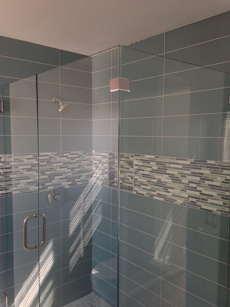 Inspiration for a large master blue tile and ceramic tile ceramic tile corner shower remodel in Orange County with a drop-in sink, shaker cabinets, medium tone wood cabinets, laminate countertops, a two-piece toilet and white walls