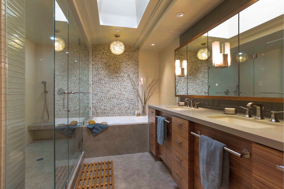 Modern inredning av ett stort en-suite badrum, med släta luckor, skåp i mörkt trä, grå kakel, bänkskiva i betong, ett platsbyggt badkar, en dusch i en alkov, ett undermonterad handfat, dusch med gångjärnsdörr, stenkakel, beige väggar, klinkergolv i porslin och grått golv