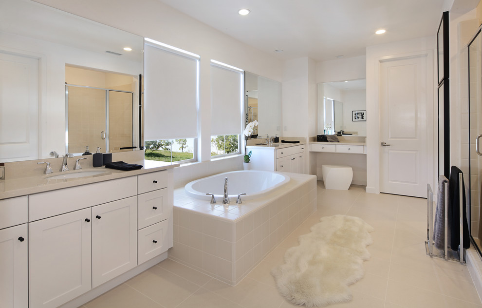 Design ideas for a large contemporary ensuite bathroom in Orange County with shaker cabinets, white cabinets, a built-in bath, an alcove shower, a two-piece toilet, beige tiles, porcelain tiles, white walls, porcelain flooring, a submerged sink and engineered stone worktops.