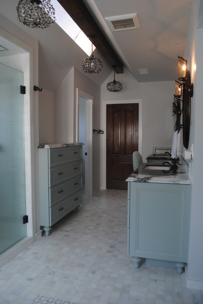 Inspiration for a large coastal master white tile and mosaic tile marble floor and white floor bathroom remodel in Orange County with furniture-like cabinets, blue cabinets, a one-piece toilet, gray walls, an undermount sink, marble countertops and a hinged shower door