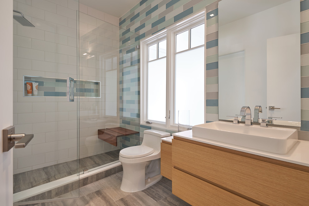 Medium sized midcentury shower room bathroom in Los Angeles with flat-panel cabinets, an alcove shower, a one-piece toilet, multi-coloured tiles, ceramic tiles, slate flooring, engineered stone worktops, grey floors, a hinged door, white worktops, medium wood cabinets and a vessel sink.