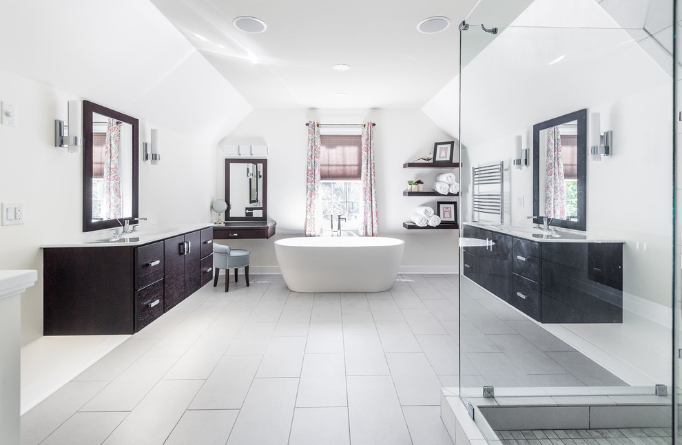 Bathroom - large contemporary master porcelain tile porcelain tile and gray floor bathroom idea in Richmond with flat-panel cabinets, dark wood cabinets, a wall-mount toilet, white walls, an integrated sink, a hinged shower door and white countertops