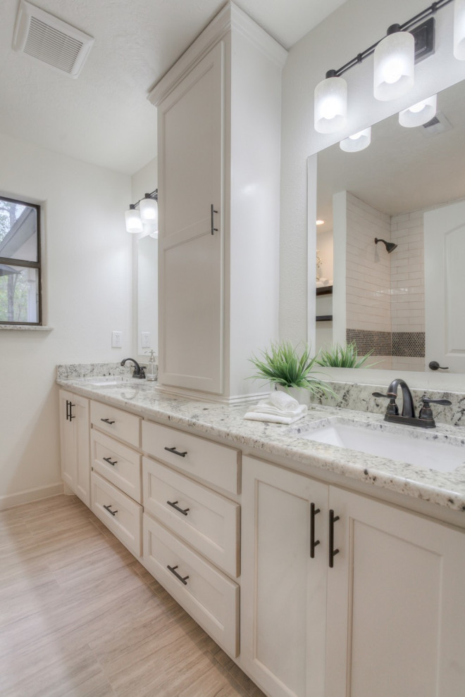 Mediterranean family bathroom in Houston with shaker cabinets, white cabinets, white walls, porcelain flooring, a submerged sink, granite worktops, multi-coloured worktops, double sinks and a built in vanity unit.