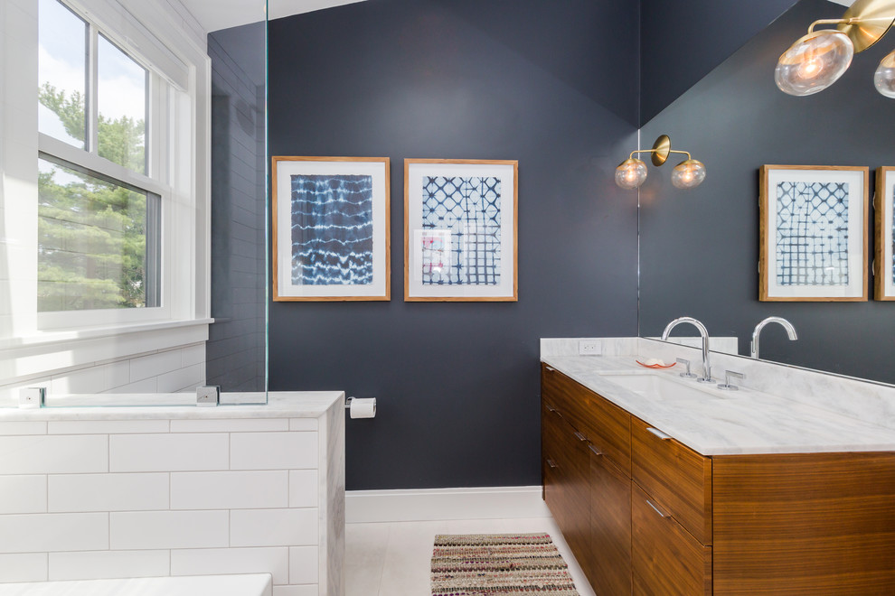 Inspiration for a mid-sized transitional kids' white tile and ceramic tile porcelain tile and white floor bathroom remodel in Boston with flat-panel cabinets, medium tone wood cabinets, a two-piece toilet, blue walls, an undermount sink, marble countertops, a hinged shower door and white countertops